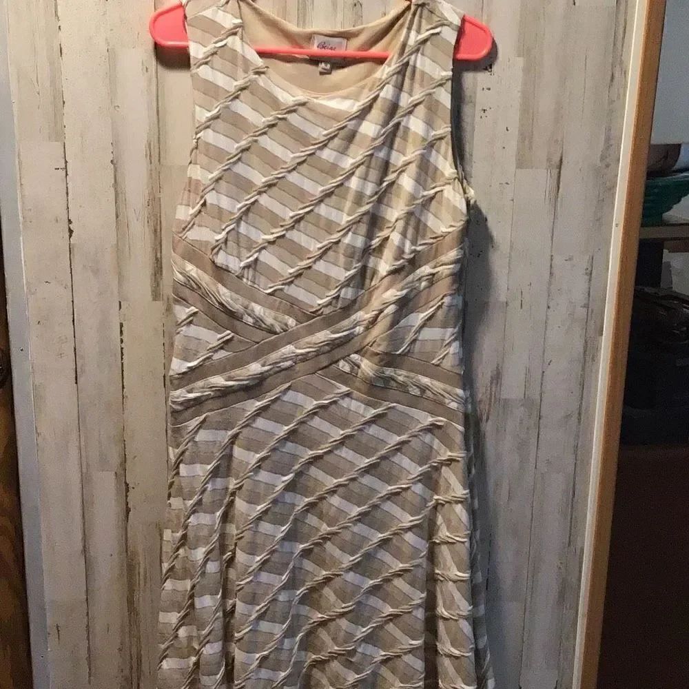 Beautifully pattern dress beige series by ECI size 12 pit to pit is 18 Length is